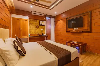 a bedroom with a bed and a flat screen tv at The Nest Inn Resort in Masinagudi