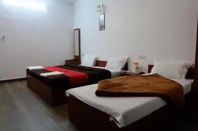 a hotel room with two beds in a room at Rosepark Residency in Ooty