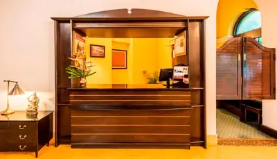 a dressing room with a mirror and a bed at Royal Orchid Metropole Mysore in Mysore