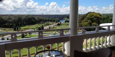 a balcony with a view of a park at Royal Orchid Brindavan Garden Palace & Spa Mysore in Belagula