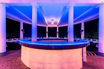 a hot tub on the porch of a mansion at night at Royal Orchid Brindavan Garden Palace & Spa Mysore in Belagula