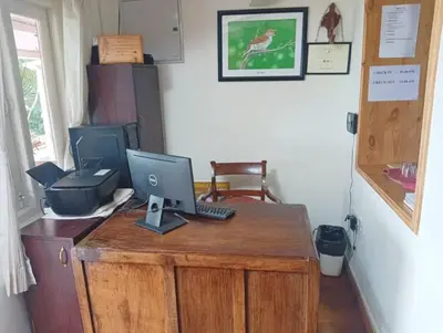 a desk with a laptop computer on top of it at Teanest Nightingale by Nature Resorts and Stays in Kotagiri