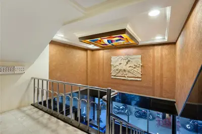 a staircase in a building with a stained glass window at Mannars Yatri Nivas Hotel in Mysore