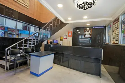 a bar with chairs and a staircase in a restaurant at Mannars Yatri Nivas Hotel in Mysore