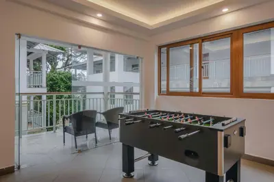 a game room with a foosball table and chairs at Elixir Hills Suites Resort and Spa in Munnar