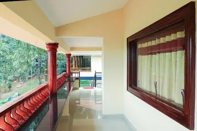 a room with a balcony with a large window at Green Garden Deluxe Room in Vayittiri