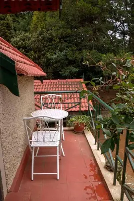 a table and chairs sitting on a patio at Stumpfields in Ooty