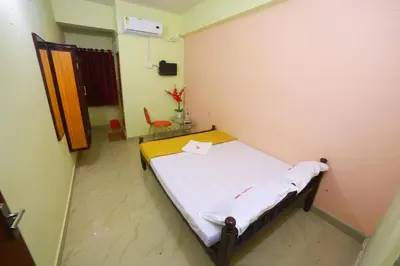 a hospital room with a bed and a chair at Avanti Inn in Guruvāyūr