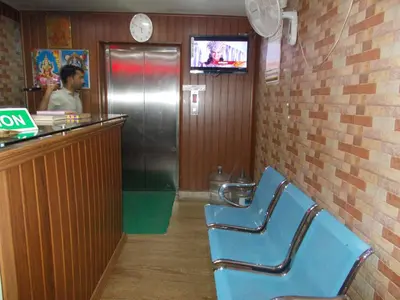 a waiting room with two blue chairs in a restaurant at Avanti Inn in Guruvāyūr