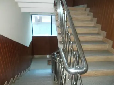 a staircase in a building with a metal railing at Avanti Inn in Guruvāyūr