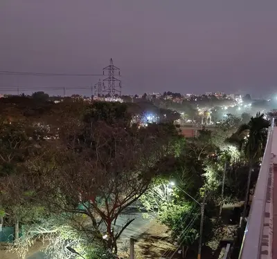 a view of a city at night with a street at Sugamya Corner Guesthouse in Mysore