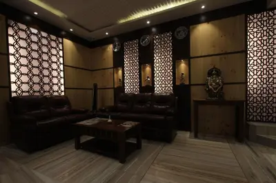 a living room with couches and a table in a room at Sandesh Pride in Mysore