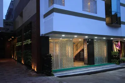 a store front of a building with lights in the window at Sandesh Pride in Mysore