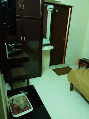 a room with a plate of food on a table at Anandkrishna Residency in Guruvāyūr