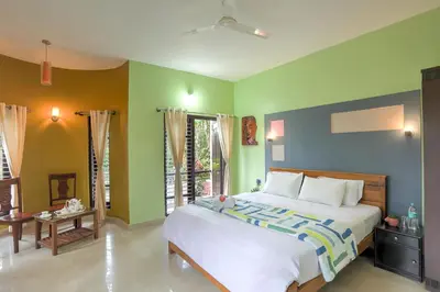 a bedroom with a bed with green and blue walls at Royal Woods Coorg in Madikeri