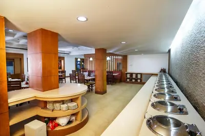 a cafeteria with a row of sinks and tables at Hotel Elite Palazzo in Kāladi