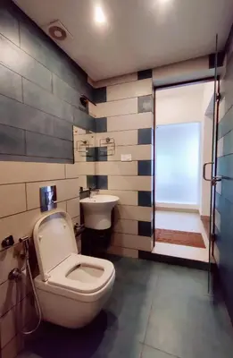 a bathroom with a toilet and a sink at ExoticaHolidays in Sultan Bathery