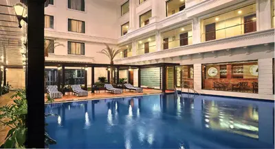a swimming pool in the middle of a building at Fortune JP Palace, Mysore - Member ITC Hotels' Group in Mysore