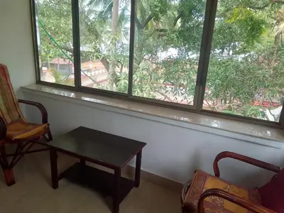 a room with a table and two chairs and a window at Liberty House - SeaView in Kozhikode