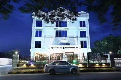 a car parked in front of a building at night at Treebo Premium Akshaya Mahal Inn in Mysore
