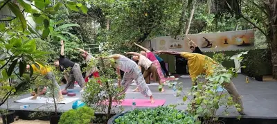 a group of people doing yoga in a garden at Lakefront Beach Homes in Cherai Beach