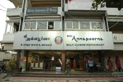 a building with people walking in front of it at Hotel Srilakshmi in Coimbatore