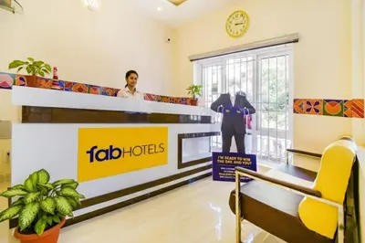 a woman standing in a waiting room at a job office at FabHotel Vinu Valley Resorts - Nr Ketti Valley View Point in Ooty