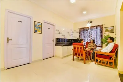 a group of people sitting in chairs in a kitchen at FabHotel Vinu Valley Resorts - Nr Ketti Valley View Point in Ooty