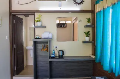 a bathroom with a sink and a mirror at Gems 9 Airport Hotel in Nedumbassery
