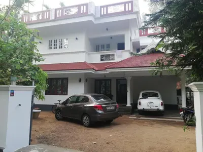 two cars parked in front of a house at Takashi Homestay North Paravur Near Muziris in North Paravur
