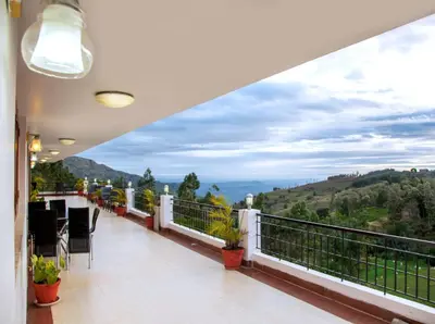 a balcony with a view of the mountains at Mount n Mist in Ooty