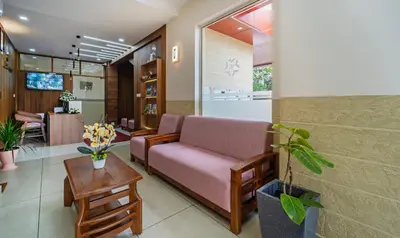 a living room with a couch and a table at Treebo Thoduvas Star Plaza Cochin Airport in Nedumbassery