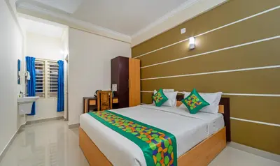 a bedroom with a large bed in a room at Treebo Thoduvas Star Plaza Cochin Airport in Nedumbassery