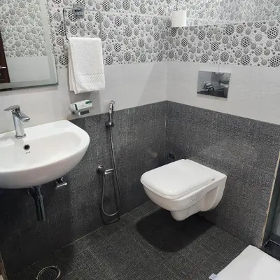 a bathroom with a toilet and a sink at Riyavar Luxury Stay in Siddapur