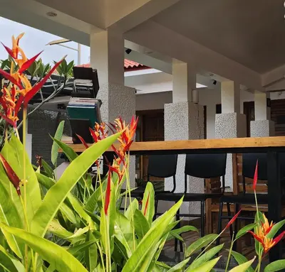 an office with green plants and a desk with a computer at Riyavar Luxury Stay in Siddapur