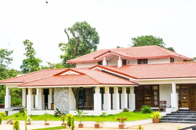 a house with a red roof at Riyavar Luxury Stay in Siddapur