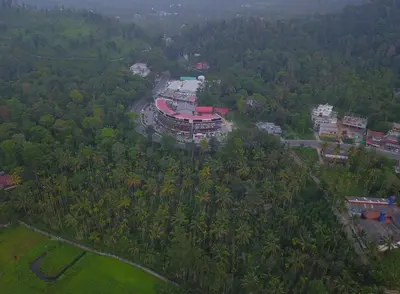 an aerial view of a building in the middle of a forest at Wayanad Royal Crown in Kalpetta