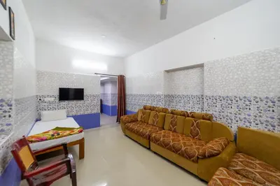 a living room with a couch and a tv at Sri Nandha Luxury Comforts in Vālpārai