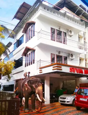 an elephant standing in front of a building at Siva Inn in Guruvāyūr