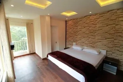 a bedroom with a large bed with a brick wall at Snowdrops Ooty in Ooty
