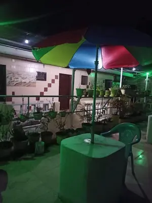 a colorful umbrella sitting on top of a table at Hill Inn Rooms an HomeStay in Ooty
