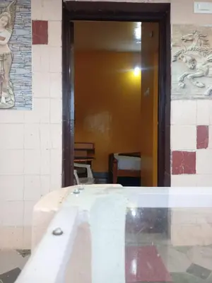 a door to a room with a sink in a building at Hill Inn Rooms an HomeStay in Ooty