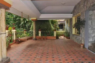 a large room with a patio with plants at Suvarna Luxury Home Stay in Mysore