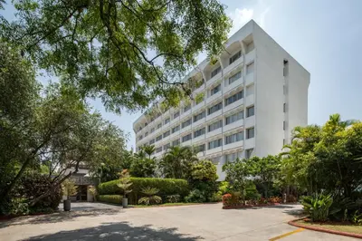 a large white building with trees in front of it at Southern Star,Mysore in Mysore