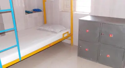 a small room with a bunk bed and a dresser at vrs dormitary in Mysore