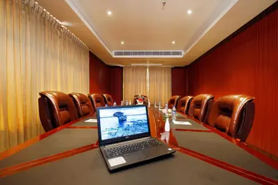 a laptop computer sitting on a table in a conference room at Hotel Park Residency in Nilambūr