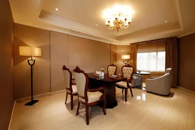 a dining room with a table and chairs and a chandelier at Hotel Park Residency in Nilambūr