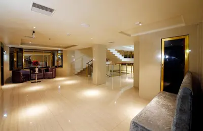 a living room with a couch and a staircase at Hotel Park Residency in Nilambūr