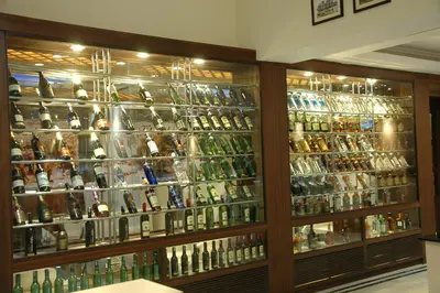 a room filled with lots of bottles of alcohol at Sandesh The Prince in Mysore