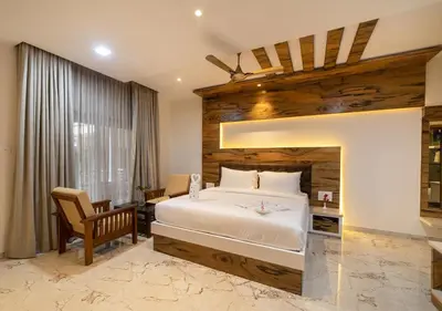 a bedroom with a large bed with a wooden wall at SR Jungle Resort in Coimbatore